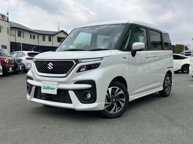 スズキ ソリオ バンディット HV MV 静岡県 2024(令6)年 0.1万km未満 ピュアホワイトP エンジンスタートボタン/スマートキー（スペアキー１本）/パワーステアリング/パワーウィンドウ/アイドリングストップ/オートエアコン/クルーズコントロール/全方位カメラ/USB入力端子/純正メモリナビ（CD.DVD.BT.フルセグ）/D席N席シートヒーター/両側パワースライドドア/ABS/横滑り防止装置/コーナーセンサー/レーンキープアシスト/オートライト/オートマチックハイビーム/LEDライト/W+サイドエアバック/衝突軽減システム