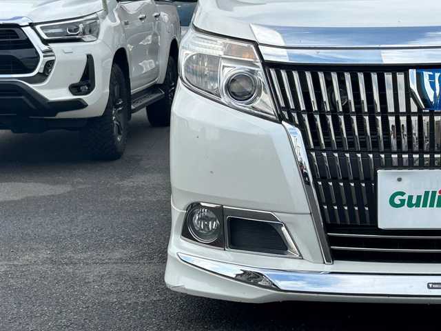 トヨタ エスクァイア ハイブリッド Xi 広島県 2015(平27)年 10.8万km ホワイトパールクリスタルシャイン モデリスタエアロ/モデリスタ17インチアルミホイール/片側パワースライドドア/アルパインビックX11インチナビ/　（DVD/CD/SD/BT/フルセグTV）/アルパインフリップダウンモニター/バックカメラ/ステアリングリモコン/ビルトインETC/前方ドライブレコーダー/前席ヒートシーター/オートリトラミラー/LEDヘッドライト/オートライト/フォグランプ/純正フロアマット/スペアキー/横滑り防止装置/盗難防止装置/保証書/取扱説明書