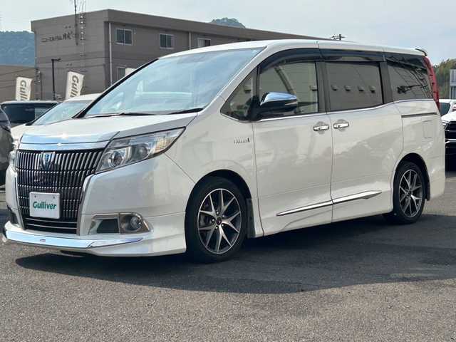 トヨタ エスクァイア ハイブリッド Xi 広島県 2015(平27)年 10.8万km ホワイトパールクリスタルシャイン モデリスタエアロ/モデリスタ17インチアルミホイール/片側パワースライドドア/アルパインビックX11インチナビ/　（DVD/CD/SD/BT/フルセグTV）/アルパインフリップダウンモニター/バックカメラ/ステアリングリモコン/ビルトインETC/前方ドライブレコーダー/前席ヒートシーター/オートリトラミラー/LEDヘッドライト/オートライト/フォグランプ/純正フロアマット/スペアキー/横滑り防止装置/盗難防止装置/保証書/取扱説明書