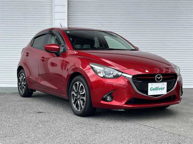 マツダ デミオ XD ツーリング 高知県 2015(平27)年 5.7万km ソウルレッドプレミアムメタリック フルセグテレビ/バックカメラ/アイドリングストップ/クルーズコントロール/ETC/ターボ/Bluetooth接続/純正ナビ/純正フロアマット/純正16インチアルミホイール/ABS/横滑り防止装置/レーンキープアシスト/盗難防止装置/オートライトオートマチックハイビーム/LEDヘッドライト/ダブル＋サイドエアバッグ/盗難防止装置/衝突被害軽減システム/バックカメラ
