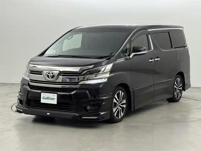 トヨタ ヴェルファイア Z Aエディション 福岡県 2017(平29)年 7.7万km バーニングブラッククリスタルシャインガラスフレーク ＴＲＤエアロ　/後席モニター　/純正９型ナビ（フルセグＴＶ）　/両側電動スライドドア　/クルーズコントロール　/衝突軽減　/コーナーセンサー　/レーンキープ　/オートライト　/横滑り防止　/オットマン　/ビルトインＥＴＣ