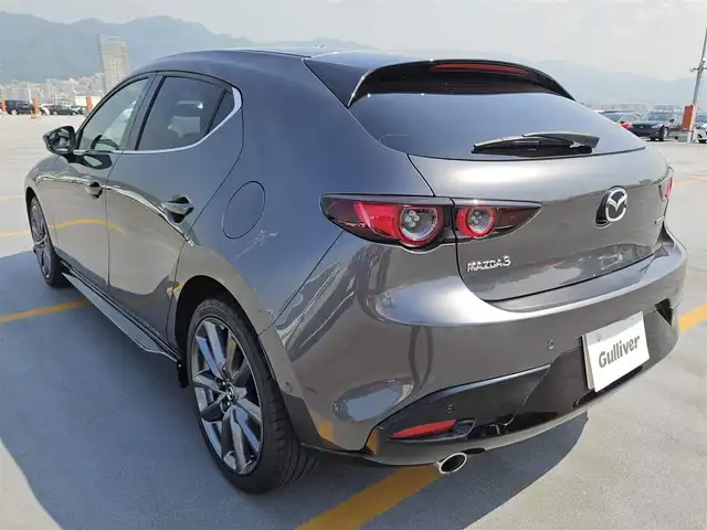マツダ マツダ３ファストバック XD バーガンディセレクション 島根県 2019(令1)年 7.4万km マシーングレープレミアムM 純正8.8型ナビ/　(AM/FM/CD/DVD)/360度ビューモニター/ビルトインETC/全車速追従機能付レーダークルーズコントロール/パーキングセンサー/i-ACTIVSENSE/・スマートブレーキサポート/・AT誤発進抑制制御/・クルージングトラフィックサポート/・車線逸脱警報システム/・レーンキープアシスト/・前後接近車両検知/・ブラインドスポットモニタリング/・交通標識認識システム/アクティブドライビングディスプレイ/ターボ/アダプティブLEDヘッドランプ/本革巻きステアリング/ステアリングヒーター/パドルシフト/レッドパーフォレーション革シート/前席シートヒーター/運転席ドライビングポジション機能/純正18インチアルミホイール/アドバンストキーレスエントリーシステム/BOSEサウンドシステム/禁煙車