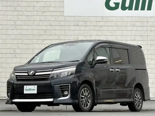 トヨタ ヴォクシー ZS 煌Ⅱ 岩手県 2016(平28)年 7.4万km ブラッキッシュアゲハガラスフレーク 禁煙車/4WD/ALPINEフリップダウンモニター/両側パワースライドドア/社外ナビ/→フルセグTV/Bluetooth/CD/DVD/バックカメラ/デジタルインナーミラー/ステアリングスイッチ/セーフティセンス/レーンキープアシスト/衝突軽減システム/横滑り防止装置/オートライト/オートハイビーム/LEDヘッドライト/LEDフォグライト/〇プッシュスタート/〇電動格納ミラー/〇ウィンカーミラー/〇ドアバイザー/〇フロアマット/〇シガーソケット/〇スマートキー/ETC