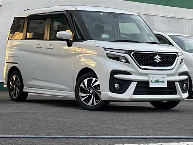 スズキ ソリオ バンディット HV MV 徳島県 2023(令5)年 5.6万km ピュアホワイトP 純正9型ナビ/全方位カメラ/VIEWスイッチ/デュアルブレーキサポートシステム/クルーズコントロール追従有/ヘッドアップディスプレイ/両側パワースライドドア/ドライブレコーダー前後/フルセグTV（走行中視聴可）/コーナーセンサー前後/純正フロアマット/USB入力端子/横滑り防止装置/レーンキープアシスト/盗難防止装置/オートライト/LEDヘッドライト/スマートキー