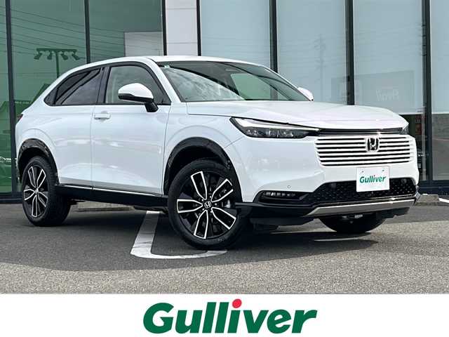 ホンダ ヴェゼル ハイブリッド e:HEV Z 岐阜県 2025(令7)年 0.1千km プラチナホワイトパール 登録時走行距離：3km/登録済み未使用車/Honda CONNECTディスプレー/バックモニター/フルセグテレビ/クルーズコントロール/ETC2.0車載器/ワイヤレス充電器/Honda SENSING/ブラインドスポットインフォメーション/アダプティブドライビングビーム(ADB)/後退出庫サポート/運転席助手席シートヒーター/ハンズフリーアクセスパワーテールゲート(予約クローズ機能付)/LEDシーケンシャルターンシグナルランプ/18インチアルミホイール/コンビシート（シートヒータ・エアシート）/ハーフレザーシート/本革巻きステアリングアイドリングストップ/保証書