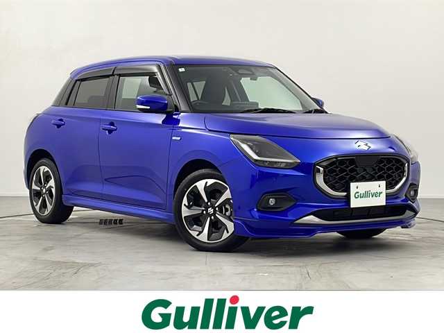 スズキ スイフト HYBRID MZ 愛知県 2024(令6)年 1.4万km 青 禁煙車/純正ディスプレイオーディオ/(AM/FM/USB/BT//iPod)/バックカメラ/ビルトインETC/フロントサイドスポイラー/シートヒーター/前後ドライブレコーダー/デュアルブレーキサポートII/ケンウッドスピーカー/プッシュスタート/スマートキー/ステアリングスイッチ/クルーズコントロール/BSM/LEDヘッドライト/オートライト/フロントフォグランプ/純正フロアマット/純正ドアバイザー