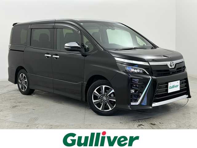 トヨタ ヴォクシー ZS 煌Ⅲ 宮城県 2020(令2)年 7.4万km ブラック 禁煙車/純正フリップダウンモニター/トヨタセーフティセンス/・プリクラッシュセーフティ/・レーンディパーチャーアラート/・オートマチックハイビーム/・先行車発進告知/クルーズコントロール/純正9インチSDナビ/・BT/CD/DVD/SD/フルセグTV/両側パワースライドドア/バックカメラ/前後ドライブレコーダー/ビルトインETC/ハーフレザーシート/革巻きステアリング/ステアリングスイッチ/プッシュスタート/スマートキー/後席ロールサンシェード/シートバックテーブル/LEDヘッドライト/LEDフォグランプ/純正16インチアルミホイール/純正ドアバイザー/社外フロアマット/横滑り防止装置/アイドリングストップ