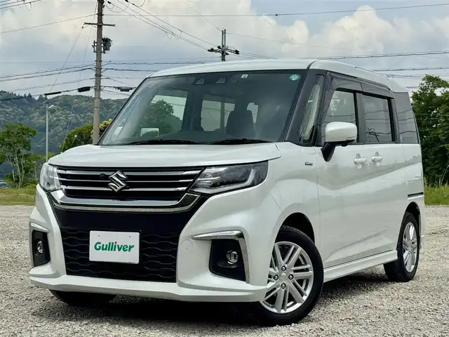 スズキ ソリオ HV MZ 兵庫県 2022(令4)年 1.1万km ピュアホワイトP 純正8インチナビ/全方位モニター/フルセグTV/Bluetooth接続可/DVD再生可/ナビ連動前後ドラレコ/レーダークルーズコントロール/ビルトインETC/両側パワースライドドア/純正15インチAW/LEDヘッドライト