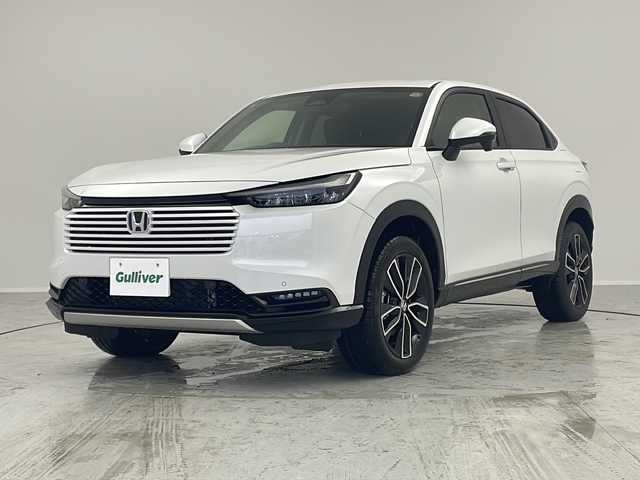 ホンダ ヴェゼル ハイブリッド e:HEV Z 茨城県 2025(令7)年 0.1千km プラチナホワイトパール 登録済未使用車/ホンダセンシング/純正9インチ Honda CONNECTナビ/ （AM/FM/BT/USB/フルセグTV）/バックカメラ/レーダークルーズコントロール/レーンキープアシスト/コーナーセンサー/ブラインドスポットモニター/オートハイビーム/ハーフレザーシート/シートヒーター/横滑り防止装置/オートLEDヘッドライト/フォグライト/純正アルミホイール/置くだけ充電/革巻きステアリング/ステアリングスイッチ/ステアリングヒーター/ETC2.0