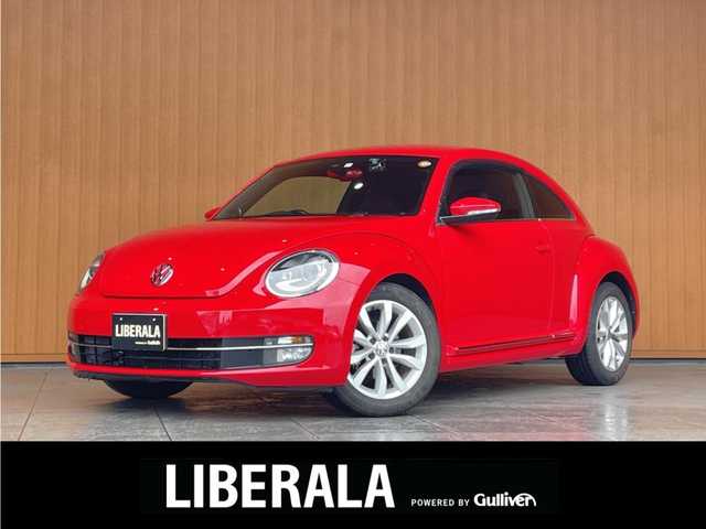 フォルクスワーゲン ザ・ビートル デザイン レザーパッケージ 愛知県 2013(平25)年 2.6万km トルネードレッド 純正メモリナビ/　CD/DVD/USB/SD/BT/AUX/バックカメラ/フルセグTV/パドルシフト/クルーズコントロール/黒革シート/シートヒーター/ヒーテッドドアミラー/前後ドライブレコーダー/F/Rフォグ/HIDヘッドライト/純正１７インチAW