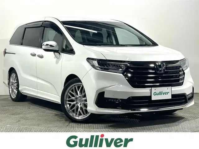 ホンダ オデッセイ ハイブリッド e:HEVアブソルート EX 大阪府 2021(令3)年 1.1万km プラチナホワイトパール 純正１１ｉｎｃナビ　後席モニター　３６０カメラ　衝突軽減ブレーキ　レーンアシスト　レーダークルーズＣ　両側パワースライドドア　ＥＴＣ　シートヒーター　コーナーセンサー　ＢＳＭ　　電動リアゲート