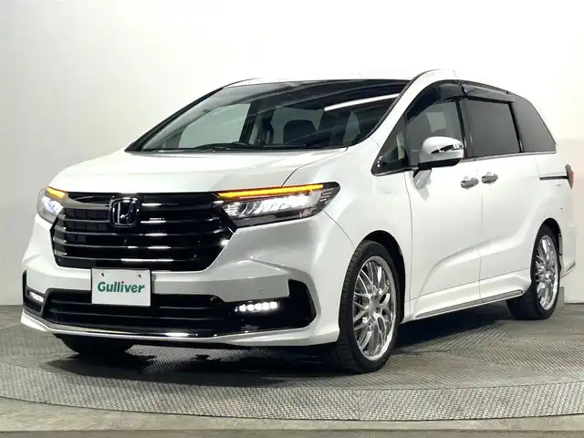 ホンダ オデッセイ ハイブリッド e:HEVアブソルート EX 大阪府 2021(令3)年 1.1万km プラチナホワイトパール 純正１１ｉｎｃナビ　後席モニター　３６０カメラ　衝突軽減ブレーキ　レーンアシスト　レーダークルーズＣ　両側パワースライドドア　ＥＴＣ　シートヒーター　コーナーセンサー　ＢＳＭ　　電動リアゲート