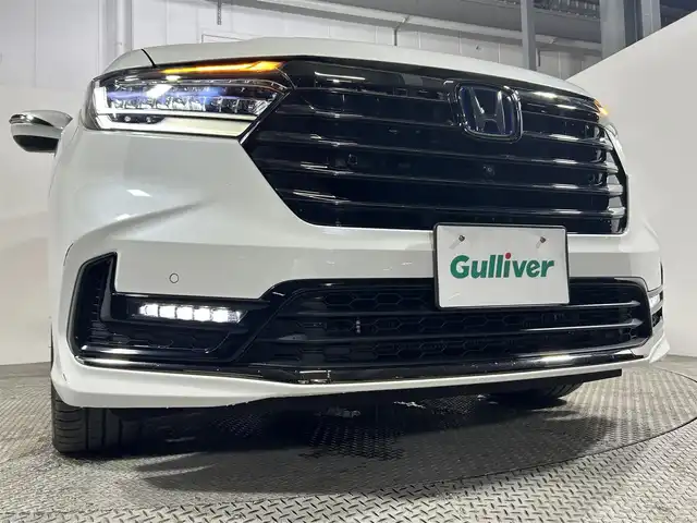 ホンダ オデッセイ ハイブリッド e:HEVアブソルート EX 大阪府 2021(令3)年 1.1万km プラチナホワイトパール 純正１１ｉｎｃナビ　後席モニター　３６０カメラ　衝突軽減ブレーキ　レーンアシスト　レーダークルーズＣ　両側パワースライドドア　ＥＴＣ　シートヒーター　コーナーセンサー　ＢＳＭ　　電動リアゲート