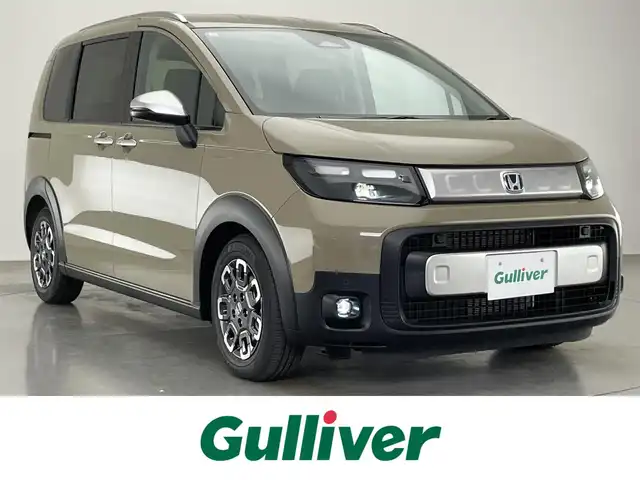 ホンダ フリード ハイブリット e:HEV クロスター 愛知県 2025(令7)年 0.1千km ベージュ 登録済未使用車　純正９型ナビ　禁煙　シートヒーター　ハーフレザー　電動パーキング　ホンダセンシング　衝突軽減　追従クルコン　ハンドル支援　コーナーセンサー　ＬＥＤオートライト　両側パワースライドドア　/登録時走行距離５ｋｍ/e:HEV クロスター　2LE40C3　6人　9インチナビ　LXM-242ZFNI(207680円)