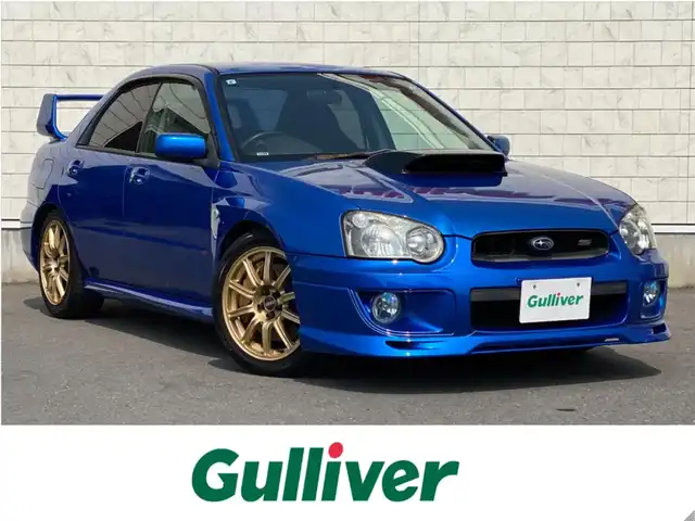 スバル インプレッサ ＷＲＸ STi 岐阜県 2003(平15)年 12.9万km WRブルーマイカ 6速MT/4WD/ターボ/純正BBS17インチAW/brembo製ゴールドキャリパー/BLITZ車庫調/HKSスポーツマフラー/Defiレーサーゲージ/カロッツェリア製メインユニット/（Bluetooth/CD/USB）/3本スポーク本革巻きステアリング/本革巻きシフトノブ/スポーツアルミペダル/キセノンヘッドライト/DCCDデフロックインジケーター/Panasonic製ツインスピーカー/Panasonic製ETC/純正フロアマット/パワーウィンドウ/マニュアルエアコン/電動格納ミラー