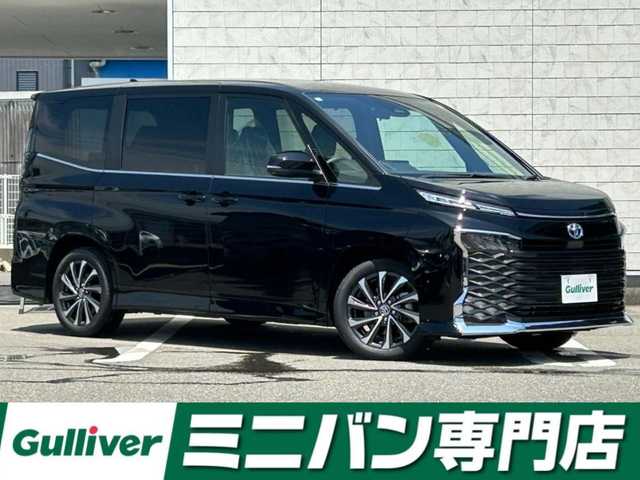トヨタ ヴォクシー ハイブリッド S－Z 福岡県 2025(令7)年 0.9万km アティチュードブラックマイカ 純正８型ディスプレイオーディオトヨタセーフティセンスレーンキープアシストオートマチックハイビームレーダークルーズコントロールバックカメラ両側パワースライドドアハーフレザーシート前席シートヒーターLEDヘッドライトオートライト純正AWETC