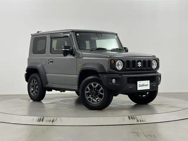 スズキ ジムニー シエラ JC 埼玉県 2024(令6)年 1.3万km ミディアムグレー ４WD/デュアルセンサーブレーキサポート/レーダークルーズコントロール/レーンキープアシスト/横滑り防止装置/盗難防止装置/ダウンヒルアシストコントロール/コーナーセンサー/衝突軽減システム/オートライト/LEDヘッドライト/純正15インチアルミホイール/ETC/プッシュスタート/スマートキー