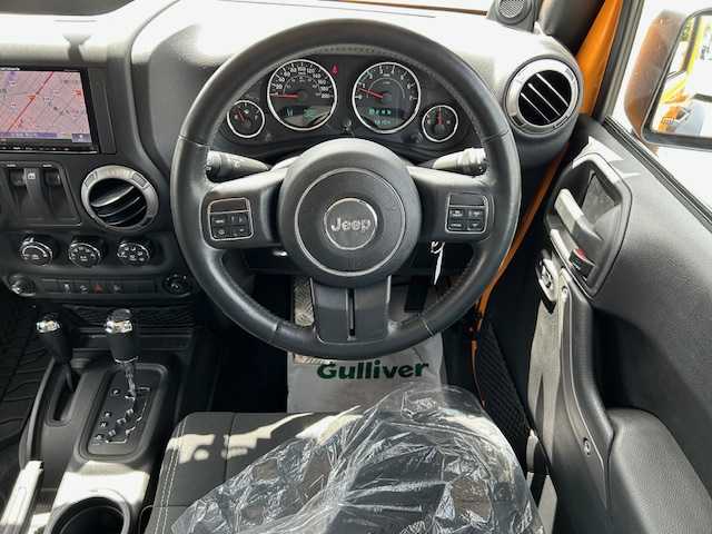 クライスラー・ジープ ジープ ラングラー マウンテン 道東・釧路十勝 2012(平24)年 7.1万km 黄 ４WD/社外SDナビ(AVIC-MRZ09)/CD/DVD/BT/フルセグTV/バックカメラ/左サイドカメラ/クルーズコントロール/革巻きステアリング/ミラーヒーター/ドアバイザー/ドライブレコーダー/ETC/キーレス