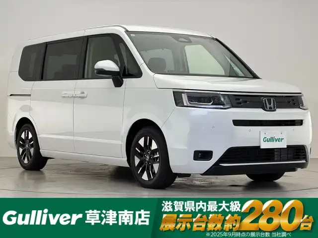 ホンダ ステップワゴン eHEV エアー EX 滋賀県 2025(令7)年 0.1千km プラチナホワイトパール 登録済未使用車/11.4インチ純正メモリーナビ/【Bluetooth/CD/DVD/USB/フルセグ】/バックカメラ/シートヒーター/2列目オットマン/両側パワースライドドア/パワーリアゲート/前後ソナー/ホンダセンシング/追従クルーズコントロール/BSM/電子パーキングブレーキ/オートホールド/LEDヘッドライト/オートハイビーム/MTモード付AT/純正16AW/WAC