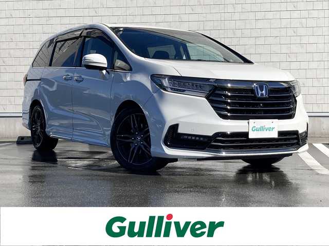 ホンダ オデッセイ ハイブリッド e:HEVアブソルート EX 静岡県 2021(令3)年 10.9万km プラチナホワイトパール Honda　SENSING/純正10インチナビ(VXU-217DYi)/　AM FM CD DVD Bluetooth USB SD AppleCarPlay/フルセグTV/前後方ドライブレコーダー/LEDオートヘッドランプ/レーダークルーズコントロール/シートヒーター(前席)/ハーフレザーシート/パワーバックドア/両側パワースライドドア/前後方クリアランスソナー/純正18インチアルミホイール/100Vソケット/ビルトインETC2.0/アラウンドビューモニター/パワーシート(前席)