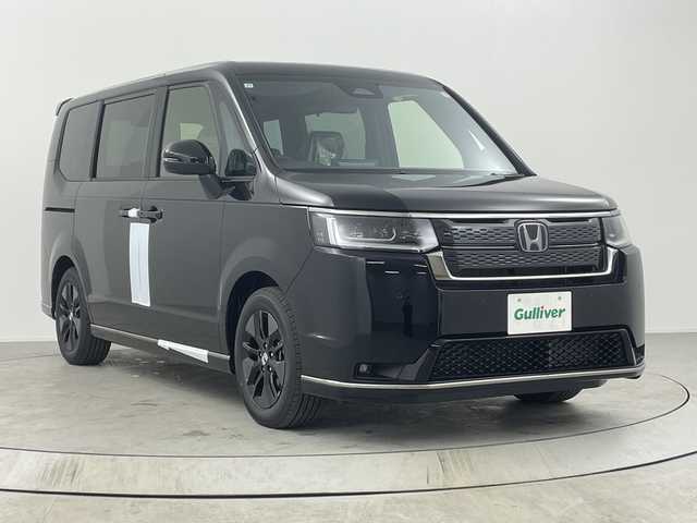 ホンダ ステップワゴン スパーダ eHEV 熊本県 2025(令7)年 0.1千km クリスタルブラックパール 純正11.4インチナビHonda CONNECTナビ（LXM-247VFLi）/・AM/FM/CD/DVD/SD/BT/USB/フルセグTV/バックカメラ/ホンダセンシング/・衝突軽減ブレーキ/・路外逸脱抑制機能/・アダプティブクルーズコントロール/・ブラインドスポットモニター/パドルシフト/電動パーキングブレーキ/ブレーキホールド/ECON/横滑り防止装置/両側パワースライドドア/電動リアゲート/前後コーナーセンサー/オットマン/LEDヘッドライト/オートライト/フォグランプ/ヘッドライトレベライザー/純正16インチアルミホイール/スマートキー/スペアキー/プッシュスタート/ワンオーナー