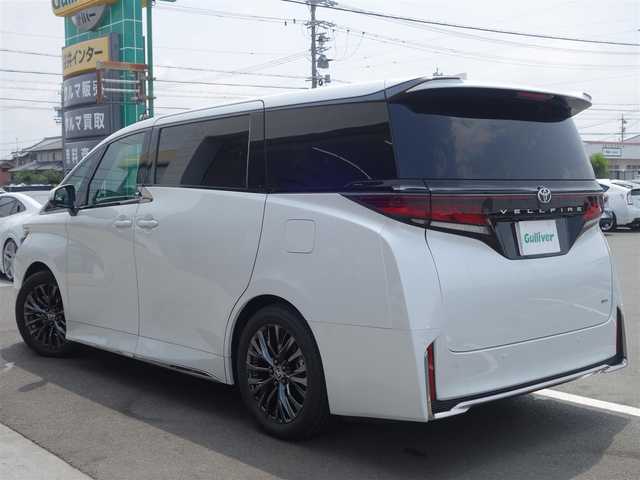 トヨタ ヴェルファイア ハイブリット Z プレミア 静岡県 2023(令5)年 0.3万km プラチナホワイトパールマイカ ワンオーナー／禁煙車/走行距離2232キロ/車検R8年8月29日/純正オプション/　・サンセットブラウンプレミアムナッパ革シート/　・13.2インチフリップダウンモニター/　・電子インナーミラー型ドライブレコーダー/　（前後方カメラ）/　・ユニバーサルステップ/トヨタセーフティセンス/BSM/トヨタチームメイト/　・アドバンストパーク/　・パーキングサポートブレーキ/　・アドバンストドライブ/　・リモート機能/左右独立ムーンルーフ/14インチディスプレイオーディオ/　ナビ／USB/HDMI/フルセグTV/　(TVキット付)／AppleCarPlay／/　Android audio/ETC2.0/おくだけ充電/ヘッドアップディスプレイ/快適温熱シート/前席パワーシート（運転席メモリー付）/2列目エグゼクティブパワーシート/　・パワーリクライニング/　・パワーオットマン/　・快適温熱シート/　・サイドテーブル/　・USB端子/5面スモーク施工/両側パワースライドドア/パワーバックドア/3眼LEDヘッドライト/プッシュスタート／スマートキー/純正フロアマット/保証書