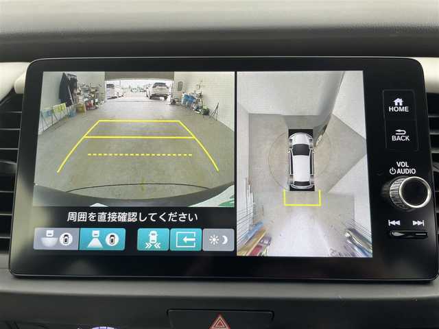 ホンダ フィット e:HEVホーム 富山県 2023(令5)年 2.1万km クリスタルブラックパール 純正ナビ（AM/FM/BT/USB/フルセグ）/全方位カメラ/ドライブレコーダー/ETC/ブラインドスポットモニター/OPグレー半革シート/シートヒーター/衝突被害軽減システム/レーダークルーズコントロール/レーンキープアシスト/コーナーセンサー/横滑り防止装置/アイドリングストップ/オートLEDライト/フォグライト/純正フロアマット/オートホールド付電子パーキング/革巻きステアリング/ステアリングスイッチ/スマートキー