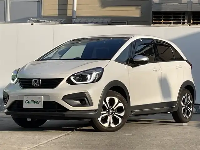 ホンダ フィット e:HEVクロスター 青森県 2022(令4)年 4.2万km プラチナホワイトパール ●ワンオーナー/●純正ＳＤナビフルセグ/（ＶＸＭ－２１５ＶＦＥＩ）/●バックモニター/●ＬＥＤヘッドライト/●純正エンスタ/●純正１６ＡＷ夏/●純正１６ＡＷ冬/●Ｈｏｎｄａ　ＳＥＮＳＩＮＧ/●カーテンエアバック/●スマートキー/●スペアキー/●新車時保証書/●取扱い説明書