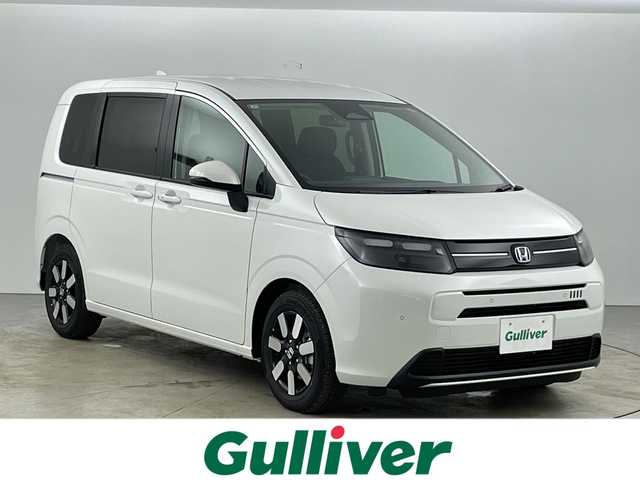 ホンダ フリード ハイブリット e:HEV AIR EX 愛知県 2025(令7)年 0.1千km プラチナホワイトパール 登録済未使用車/6人乗り/純正9インチナビ/（AM/FM/Bluetooth/フルセグTV/USB)/バックカメラ/ホンダセンシング/・衝突軽減ブレーキ/・レーンキープアシスト/・アダプティブクルーズコントロール/・先行車発進お知らせ機能/・オートマチックハイビーム/・パーキングセンサーシステム/・ブラインドスポットモニター/ハーフレザーシート/シートヒーター/両側パワースライドドア/アイドリングストップ/純正15インチアルミホイール/スマートキー/スペアキー1本/プッシュスタート/LEDヘッドライト/横滑り防止装置