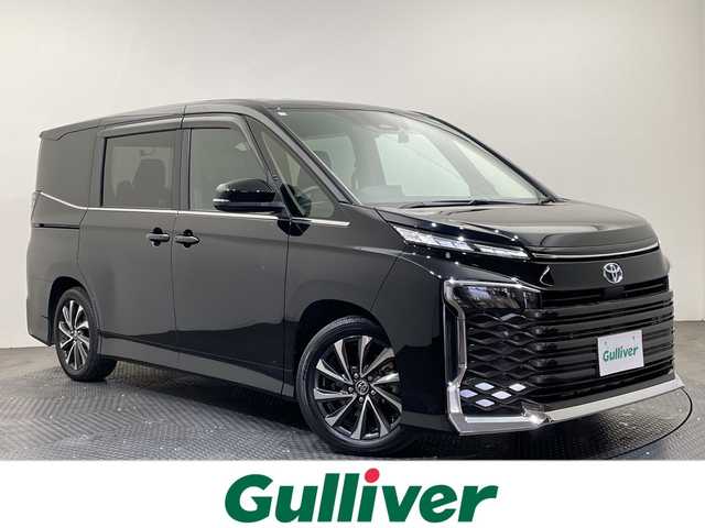 トヨタ ヴォクシー ハイブリッド S－Z 愛媛県 2023(令5)年 2.7万km アティチュードブラックマイカ 快適利便パッケージ(High)/純正14インチ後席モニター　/CD・DVDデッキ　/ブラインドスポットモニター　/______________________/純正１０型ナビ／純正１４型フリップダウンモニター／快適利便／ブラインドスポットモニター／両側電動スライドドア／電動リアゲート／衝突被害軽減ブレーキ／シートヒーター／ＴＶ／Ｂｌｕｅｔｏｏｔｈ／禁煙