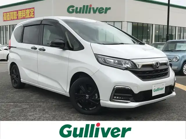 ホンダ フリード ハイブリット G ブラックスタイル 鳥取県 2022(令4)年 2.6万km プラチナホワイトパール 純正9インチナビ/フルセグ/CD/DVD/BT/USB/バックカメラ/ホンダセンシング/レーンキープアシスト/レーダークルーズコントロール/両側パワースライドドア/ビルトインETC/ドライブレコーダー/前席シートヒーター/LEDヘットライト/フォグライト/純正15インチアルミホイール/プッシュエンジンスタート/スマートキー×２/フロアマット・ドアバイザー