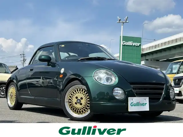ダイハツ コペン ULTIMATE EDITION 愛知県 2006(平18)年 5.5万km ダークグリーンマイカ オープンカー/メモリーナビ（FM/AM/フルセグTV/USB/BT)/ETC/シートヒーター/純正RECARDシート/純正ビルシュタインショック/純正MOMOステアリング/純正フロアマット/D-SPORTマフラー/カーボンリアスポイラー/ENKEI15インチAW/パワーステアリング/パワーウィンドウ/ABS/ハロゲンライト