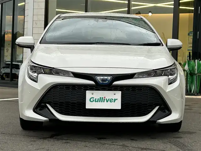 トヨタ カローラ スポーツ ハイブリッドG 愛媛県 2019(令1)年 3.1万km ホワイトパールクリスタルシャイン ワンオーナー/純正ディスプレイオーディオ(ナビ登録済み)/Bluetooth/USB/バックカメラ/ビルトインETC/ドライブレコーダー/トヨタセーフティセンス/アダクティブクルーズコントロール/プリクラッシュセーフティ/ブラインドスポットモニター/リヤクロストラフィックアラート/レーンキープアシストシステム/パーキングサポートブレーキ/ロードサインアシスト/LEDヘッドライト/オートライト/オートマチックハイビーム/電動パーキング/オートホールド/ドライブモード/純正16インチアルミホイール/純正フロアマット/純正ドアバイザー/トノカバー/プッシュスタート/スマートキー/スペアキー１本/保証書/取扱説明書