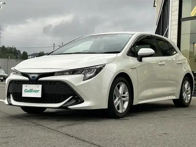 トヨタ カローラ スポーツ ハイブリッドG 愛媛県 2019(令1)年 3.1万km ホワイトパールクリスタルシャイン ワンオーナー/純正ディスプレイオーディオ(ナビ登録済み)/Bluetooth/USB/バックカメラ/ビルトインETC/ドライブレコーダー/トヨタセーフティセンス/アダクティブクルーズコントロール/プリクラッシュセーフティ/ブラインドスポットモニター/リヤクロストラフィックアラート/レーンキープアシストシステム/パーキングサポートブレーキ/ロードサインアシスト/LEDヘッドライト/オートライト/オートマチックハイビーム/電動パーキング/オートホールド/ドライブモード/純正16インチアルミホイール/純正フロアマット/純正ドアバイザー/トノカバー/プッシュスタート/スマートキー/スペアキー１本/保証書/取扱説明書