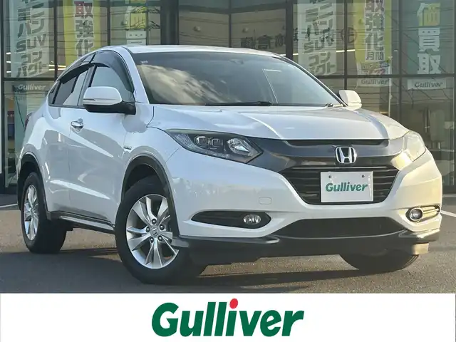 ホンダ ヴェゼル ハイブリッド X 岡山県 2014(平26)年 9.3万km ホワイトオーキッドパール 登録時走行距離92515km/カロッツェリアナビ/フルセグTV(AM.FM.CD.DVD.TV.BT)/バックカメラ/ETC/衝突軽減ブレーキ/横滑り防止装置/クルーズコントロール/オートライト/アイドリングストップ/16インチ純正AW/純正フロアマット/スマートキー/ドアバイザー