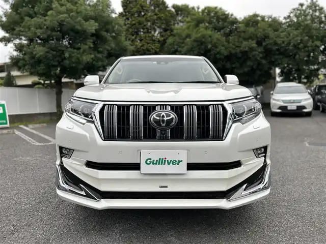 トヨタ ランドクルーザー プラド TX Lパッケージ 東京都 2019(平31)年 2.1万km ホワイトパールクリスタルシャイン ワンオーナー/メーカーオプションナビ（8インチ）/・Bluetoothオーディオ/USBオーディオ/・DVD/Blu-ray/フルセグTV/マルチテレインモニター/電動ムーンルーフ/純正19インチアルミホイール/クリアランスソナー&バックソナー/木目調・本革巻きステアリングホイール/Toyota Safety Sense/ビルトインETC2.0/取扱説明書/保証書/スペアキー1本