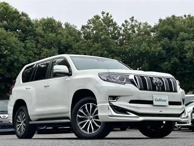 トヨタ ランドクルーザー プラド TX Lパッケージ 東京都 2019(平31)年 2.1万km ホワイトパールクリスタルシャイン ワンオーナー/メーカーオプションナビ（8インチ）/・Bluetoothオーディオ/USBオーディオ/・DVD/Blu-ray/フルセグTV/マルチテレインモニター/電動ムーンルーフ/純正19インチアルミホイール/クリアランスソナー&バックソナー/木目調・本革巻きステアリングホイール/Toyota Safety Sense/ビルトインETC2.0/取扱説明書/保証書/スペアキー1本
