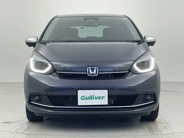 ホンダ フィット e:HEVリュクス 愛知県 2025(令7)年 0.4万km メテオロイドグレーメタリック 純正ナビ/・フルセグ/・Bluetooth/・AppleCarPlay/・AndroidAuto/・AM/FM/アラウンドビューモニター/追従クルコン/ビルドインＥＴＣ2.0/前席シートヒータ/衝突軽減ブレーキ/ブラインドスポットモニター/レーンキープアシスト/ステアリングヒーター/衝突軽減ブレーキ（CMBS）/誤発進抑制機能/歩行者事故低減ステアリング/路外逸脱抑制機能/渋滞追従機能付きアダプティブクルーズコントロール（ACC）/車線維持支援システム（LKAS）/先行車発進お知らせ機能/標識認識機能/オートハイビーム/ワイヤレス充電/電動パーキングブレーキ/オートホールド/LEDヘッドライト