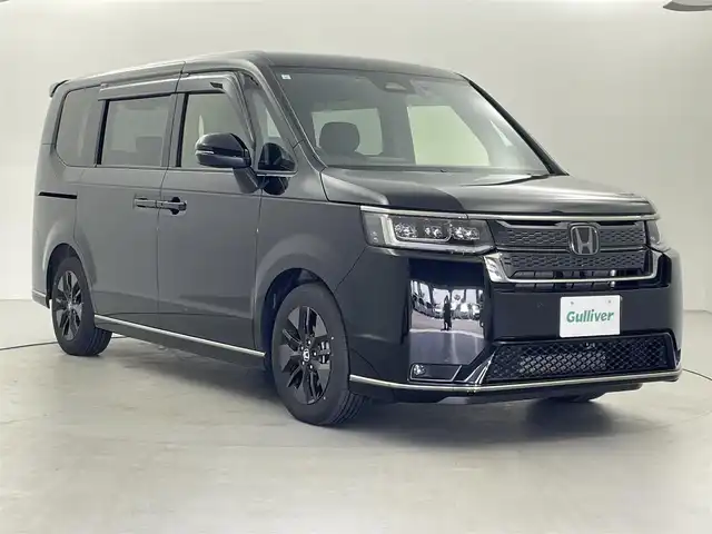 ホンダ ステップワゴン スパーダ 福井県 2024(令6)年 0.6万km クリスタルブラックパール 9型純正ナビ　/【AM/FM/CD/DVD/Bluetooth/フルセグ】/ホンダセンシング/-車線逸脱警報/-レーンキープアシスト/-BSM/-踏み間違い防止/-オートクルーズコントロール/全方位カメラ/両側パワースライドドア　/パワーバックドア　/ハーフレザーシート　/シートヒーター　/LEDライト/ETC/ドライブレコーダー前後