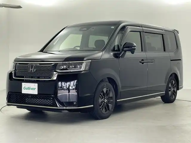 ホンダ ステップワゴン スパーダ 福井県 2024(令6)年 0.6万km クリスタルブラックパール 9型純正ナビ　/【AM/FM/CD/DVD/Bluetooth/フルセグ】/ホンダセンシング/-車線逸脱警報/-レーンキープアシスト/-BSM/-踏み間違い防止/-オートクルーズコントロール/全方位カメラ/両側パワースライドドア　/パワーバックドア　/ハーフレザーシート　/シートヒーター　/LEDライト/ETC/ドライブレコーダー前後