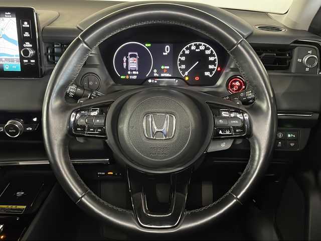 ホンダ ヴェゼル ハイブリッド e:HEV Z 広島県 2021(令3)年 4.8万km プラチナホワイトパール 純正９型ナビ/バックカメラ/シートヒーター/電動リアゲート/ワイヤレス充電/ブラインドスポットモニター/ＥＴＣ２．０/前後ドラレコ/オートハイビーム/ステアリングヒーター/レーダークルーズコントロール/衝突軽減/レーンキープアシスト/踏み間違い防止/純正18インチアルミホイール(225/50/R18)/エアバッグ(運転席/助手席/サイド/カーテン)