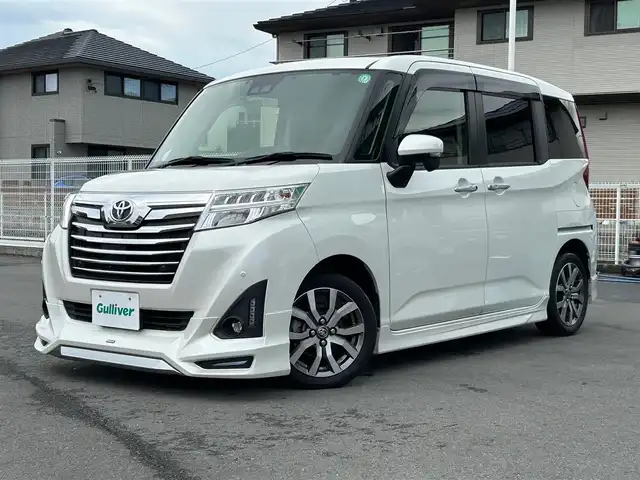 トヨタ ルーミー カスタムG－T 静岡県 2019(令1)年 4.4万km パール エンジンスタートボタン/パワーステアリング/パワーウィンドウ/アイドリングストップ/スマートキー/オートエアコン/クルーズコントロール/SDナビ（CD.DVD)/Bluetooth/SDミュージックサーバー/TV（フルセグ）/ETC/ウォークスルー/純正フロアマット/シートヒーター/両側パワースライドドア/エアロパーツ（モデリスタ）/純正アルミホイール/ABS/横滑り防止装置/コーナーセンサー前後/レーンキープアシスト/オートライト/オートマチックハイビーム/LEDライト/Wエアバッグ/衝突軽減システム