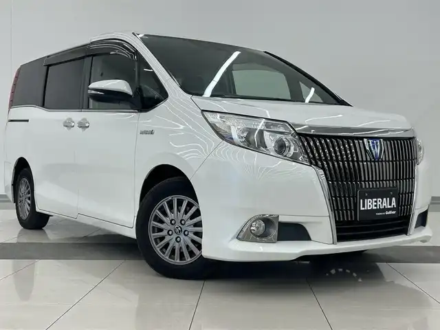 トヨタ エスクァイア ハイブリッド Gi 岡山県 2015(平27)年 10.7万km ホワイトパールクリスタルシャイン DOPナビ　NSZT-Y64T/フルセグTV（AM.FM.TV.CD.DVD.BT）/アルパインリアフリップダウンモニター/両側パワースライドドア/バックカメラ/ETC/ドライブレコーダー/レザーシート/シートヒーター/クルーズコントロール/オートライト/オートマチックハイビーム/フォグライト/サングラスホルダー/ステアリングスイッチ/ワイヤレス充電/ＬＥＤヘッドライト/スペアキー/15インチ純正AW/純正フロアマット