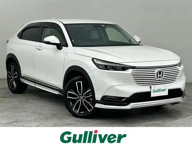 ホンダ ヴェゼル ハイブリッド e:HEV Z 道央・札幌 2022(令4)年 4.1万km プラチナホワイトパール ・４WD/・寒冷地仕様/・純正ロアスカート（F・R）/・純正ガーニッシュ（S・R）/・ホンダコネクトディスプレイ/　BT／AppleCarPlay／AndroidAuto/・マルチビューカメラシステム/・純正ビルトインETC2.0 /・純正前後ドライブレコーダー/・ホンダセンシング/・衝突軽減ブレーキ/・レーンキープアシスト/・横滑り防止装置/・アイドリングストップ/・ブラインドスポットインフォメーション/・ハーフレザーシート/・前席シートヒーター/・ステアリングヒーター/・ワイヤレス充電/・パドルシフト/・テールゲートスポイラー/・純正AW18インチ/・スマートキー/・プッシュスタート/・スペアキー