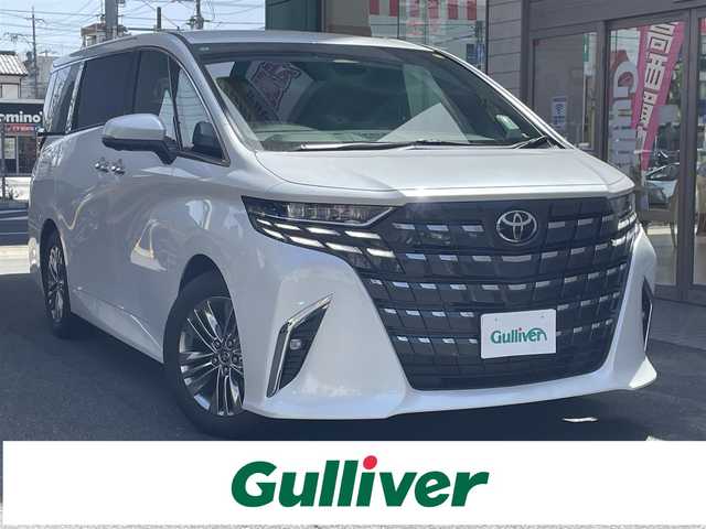 トヨタ アルファードハイブリット Z 愛知県 2025(令7)年 0.2万km プラチナホワイトパールマイカ ワンオーナー/左右独立パノラマルーフ＆電動シェード〈MOP〉/ユニバーサルステップ〈MOP〉/TOYOTAチームメイト〈MOP〉/・アドパンストパーク/・パーキングサポートブレーキ/・アドバンストドライブ/・フロントクロストラフィックアラート/・レーンチェンジアシスト/・ドライバーモニターカメラ/・パドルシフト/両側パワースライドドア/パワーバックドア/14インチディスプレイオーディオプラス/・車載ナビ／Bluetooth／HDMI/・地デジTV／Miracast/アラウンドビューカメラ/黒合皮シート/前席パワーシート/前席2列目シートヒーター＆ベンチレーション/2列目エグゼクティブパワーシート/デジタルインナーミラー/3眼LEDヘッドライト/フォグランプ/置くだけ充電/ビルトインETC2.0/TOYOTA Safety Sense/・プリクラッシュセーフティ/・レーントレーシングアシスト/・レーンディパーチャーアラート/・レーダークルーズコントロール/・アダプティブハイビーム/ブラインドスポットモニター/純正18インチAW