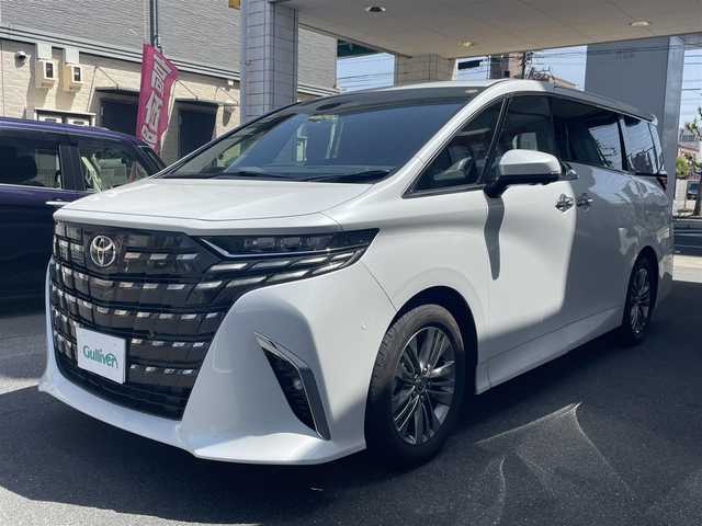 トヨタ アルファードハイブリット Z 愛知県 2025(令7)年 0.2万km プラチナホワイトパールマイカ ワンオーナー/左右独立パノラマルーフ＆電動シェード〈MOP〉/ユニバーサルステップ〈MOP〉/TOYOTAチームメイト〈MOP〉/・アドパンストパーク/・パーキングサポートブレーキ/・アドバンストドライブ/・フロントクロストラフィックアラート/・レーンチェンジアシスト/・ドライバーモニターカメラ/・パドルシフト/両側パワースライドドア/パワーバックドア/14インチディスプレイオーディオプラス/・車載ナビ／Bluetooth／HDMI/・地デジTV／Miracast/アラウンドビューカメラ/黒合皮シート/前席パワーシート/前席2列目シートヒーター＆ベンチレーション/2列目エグゼクティブパワーシート/デジタルインナーミラー/3眼LEDヘッドライト/フォグランプ/置くだけ充電/ビルトインETC2.0/TOYOTA Safety Sense/・プリクラッシュセーフティ/・レーントレーシングアシスト/・レーンディパーチャーアラート/・レーダークルーズコントロール/・アダプティブハイビーム/ブラインドスポットモニター/純正18インチAW