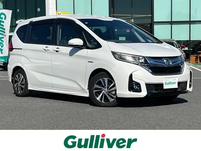 ホンダ フリード ハイブリット EX 奈良県 2017(平29)年 6.8万km ホワイトオーキッドパール 純正ナビ（VXM-174VFXi）/（フルセグ/BT/CD/DVD)/レーダークルーズコントロール/バックカメラ/衝突軽減システム/レーンキープアシスト/両側パワースライドドア/ハーフレザーシート/前席シートヒーター/後席サンシェード/オートライト/前後ドライブレコーダー/ETC/純正15インチＡＷ/取り扱い説明書/スペアキーＸ１