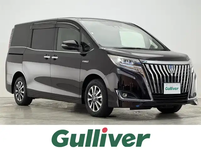 トヨタ エスクァイア ハイブリッド Gi 滋賀県 2017(平29)年 7.5万km ボルドーマイカメタリック 純正10インチナビ/【Bluetooth/CD/DVD/フルセグTV】/純正フリップダウンモニター/バックカメラ/クルーズコントロール/衝突軽減ブレーキ/両側パワースライドドア/レザーシート/D/Nシートヒーター/LEDヘッドライト/オートマチックハイビーム/ビルトインETC2.0/前方ドライブレコーダー/デジタルインナーミラー/プッシュスタート/スマートキー/ステアリングリモコン