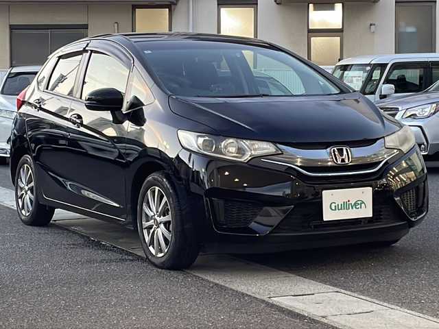 ホンダ フィット ハイブリット Lパッケージ 岡山県 2014(平26)年 9.1万km クリスタルブラックパール 登録時走行距離90957km/純正SDナビ/(AM/FM/DISC/TV/BT)/衝突被害軽減システム/クルーズコントロール/バックカメラ/ETC/ドライブレコーダー/チップアップシート/プッシュスタート/スマートキー/スペアキー/スターターキー/社外15インチアルミホイール/記録簿/保証書/取扱説明書