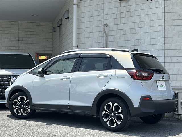 ホンダ フィット e:HEVクロスター 神奈川県 2020(令2)年 1.1万km プレミアムサンライトホワイトパール ワンオーナー/レーダークルーズコントロール/ETC/純正ナビ（SD/AM/FM/BT/DVD/TV）/純正ドラレコ/純正フロアマット/オートライト/ホンダセンシング/アイドリングストップ/バックカメラ/LEDヘッドライト/盗難防止装置/レーンキープアシスト/ABS/横滑り防止装置/ブレーキホールド/取扱説明書/保証書/スペアキー×1
